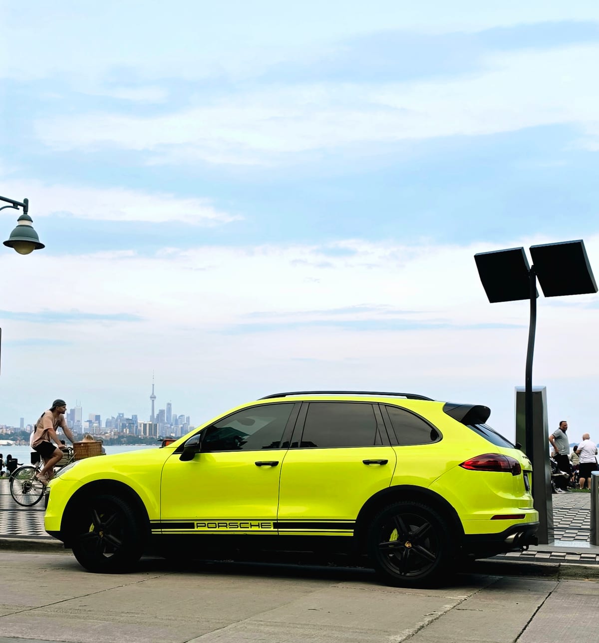 High-value luxury SUV parked at the Toronto waterfront with the downtown skyline behind, ready for air-freight DG export from YYZ